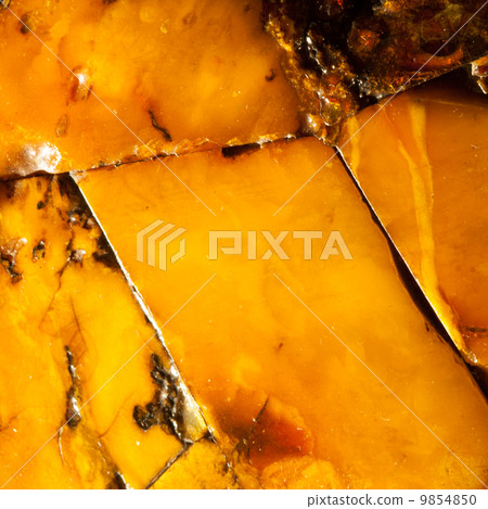 Closeup of golden amber as background or texture. Resin gem. Closeup of golden amber as background or texture. Resin gem. 9854850