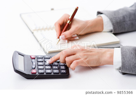 Hands working on the calculator Hands working on the calculator 9855366