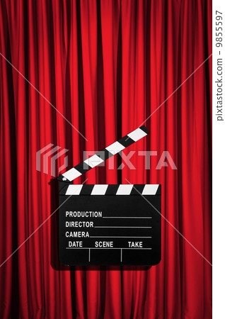 Movie clapper board against curtain 9855597