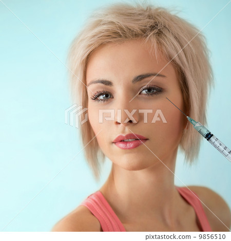 Beautiful woman gets an injection in her face Beautiful woman gets an injection in her face 9856510