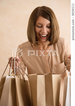 Portrait of happy smiling woman holding shopping bags 9856511