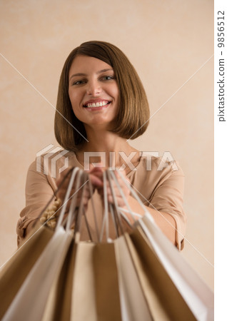 Portrait of happy smiling woman holding shopping bags Portrait of happy smiling woman holding shopping bags 9856512