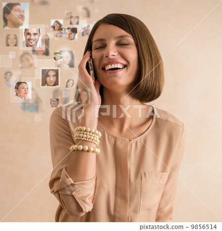 Woman using her smartphone and lots of people portraits around h Woman using her smartphone and lots of people portraits around h 9856514