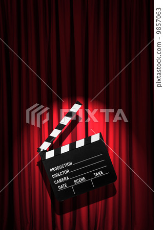 Movie clapper board against curtain 9857063
