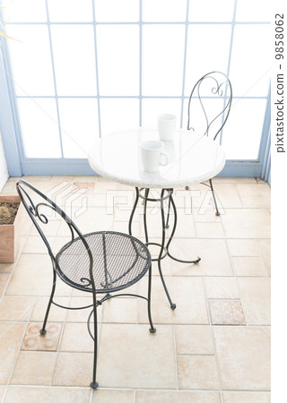 A table seat of a cafe where two drinks were placed 9858062