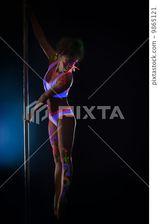 Strong young dancer posing with UV pattern on body 9865121