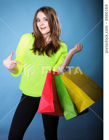 young woman with paper multi coloured shopping bag young woman with paper multi coloured shopping bag 9866169