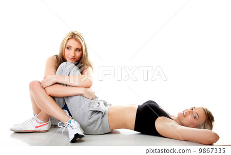 Two women doing fitness exercise isolated Two women doing fitness exercise isolated 9867335