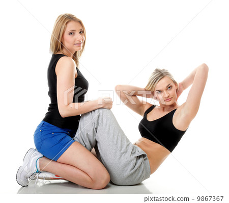 Two women doing fitness exercise isolated Two women doing fitness exercise isolated 9867367