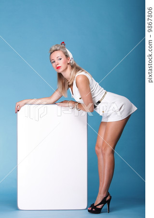 Sexy pinup girl with a blank presentation board 9867806