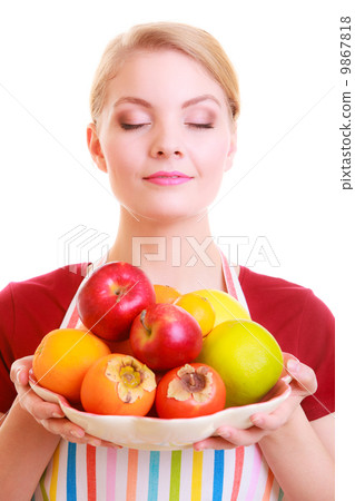 Happy housewife or chef in kitchen apron offering fruits isolated 9867818