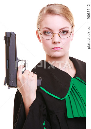 Woman lawyer attorney in polish black green gown with gun 9868242