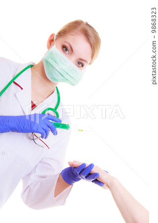 Hands of doctor nurse with syringe giving injection to patient Hands of doctor nurse with syringe giving injection to patient 9868323