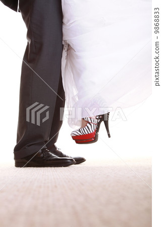 Wedding couple. Legs of the groom and the bride. 9868833