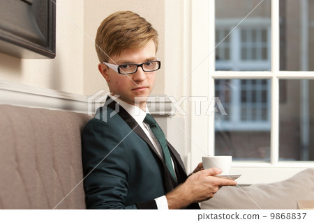 Young handsome stylish man in cafe with coffee Young handsome stylish man in cafe with coffee 9868837
