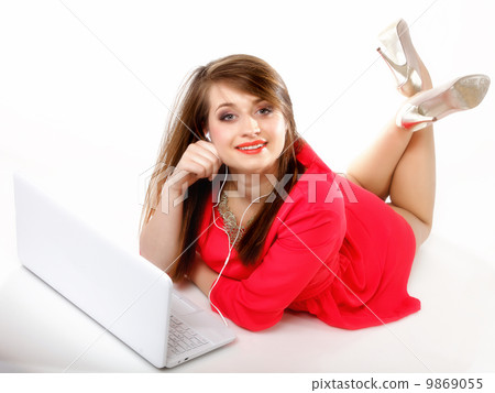 Cute girl with headphones and laptop lying Cute girl with headphones and laptop lying 9869055