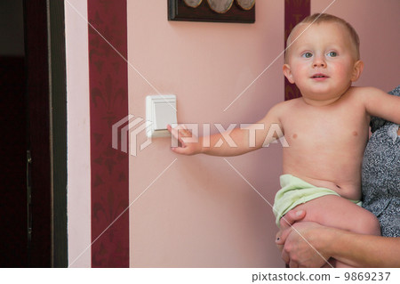 interested little boy turning off the light-switch interested little boy turning off the light-switch 9869237