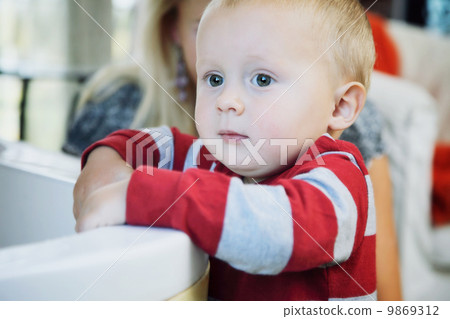 Portrait of little pensive baby boy indoor 9869312