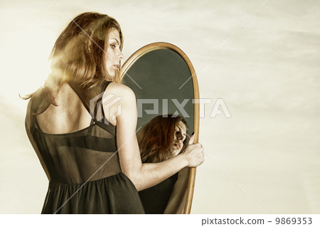 thoughtful woman looks at the reflection in mirror thoughtful woman looks at the reflection in mirror 9869353