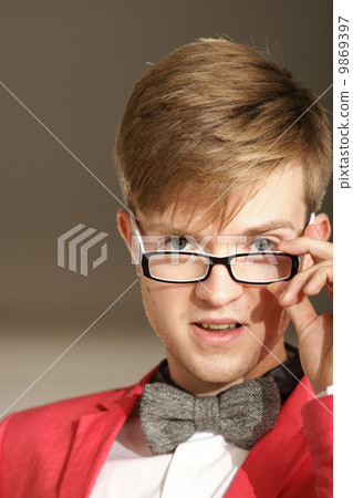Young handsome stylish man posing indoor Young handsome stylish man posing indoor 9869397