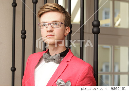 Young handsome stylish man posing indoor Young handsome stylish man posing indoor 9869461