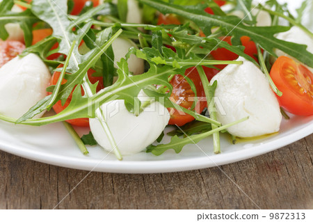 salad from arugula tomatos and baby mozzarella salad from arugula tomatos and baby mozzarella 9872313