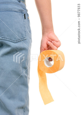 Roll of yellow toilet paper in hand 9877833