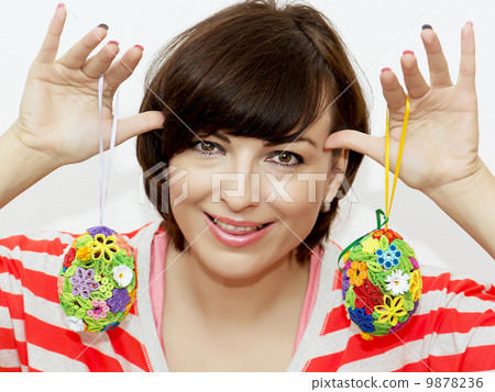 Young woman joking with decorative easter eggs Young woman joking with decorative easter eggs 9878236