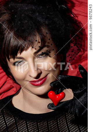 Smiling caucasian woman with red heart in hand Smiling caucasian woman with red heart in hand 9878243