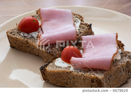 Tasty toasts with butter, ham and cherry tomatoes Tasty toasts with butter, ham and cherry tomatoes 9878620