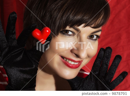 Beautiful young smiling woman with red heart in her hand Beautiful young smiling woman with red heart in her hand 9878701