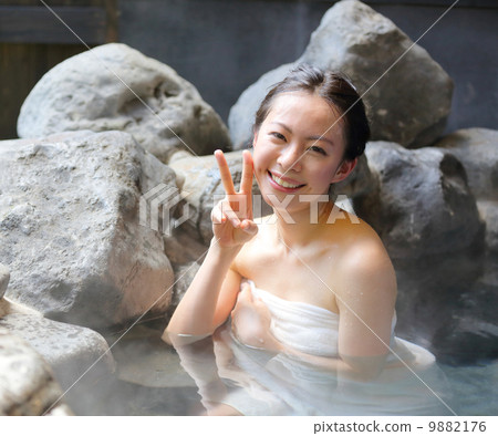 A woman entering a hot spring 9882176