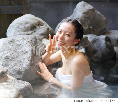 A woman entering a hot spring A woman entering a hot spring 9882177