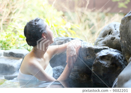 A woman entering a hot spring A woman entering a hot spring 9882201