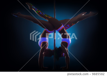 Slender pole dancers posing standing on hands 9885582