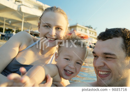 Happy young family at the seaside Happy young family at the seaside 9885716