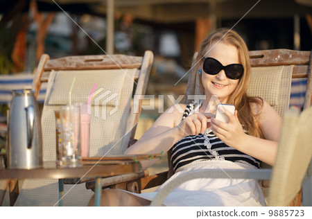 Woman sending an sms on her mobile Woman sending an sms on her mobile 9885723