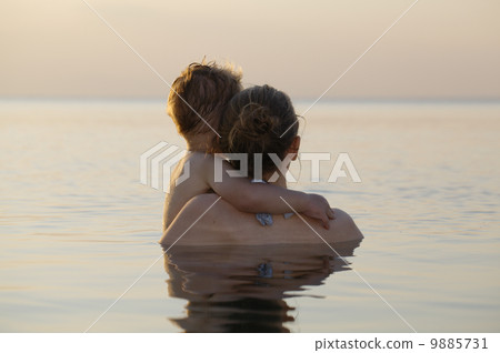 Mother and son watching the sunset Mother and son watching the sunset 9885731