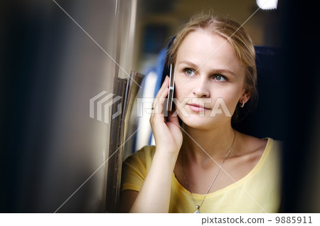 Woman listening to a call on her mobile Woman listening to a call on her mobile 9885911