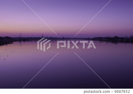 紫色的美好的日落和水的表面的反射 9887652