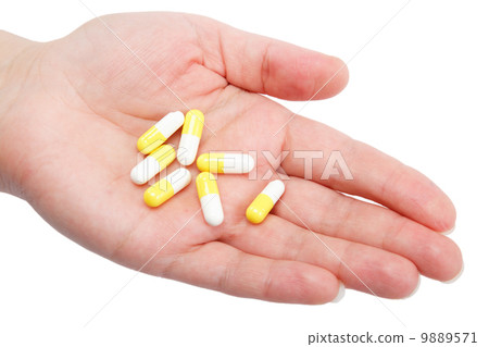 Pills in woman hand isolated on white background Pills in woman hand isolated on white background 9889571