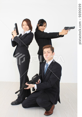 A business team with a gun A business team with a gun 9890699