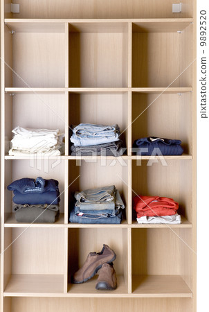 Clothes in wardrobe on the shelves 9892520