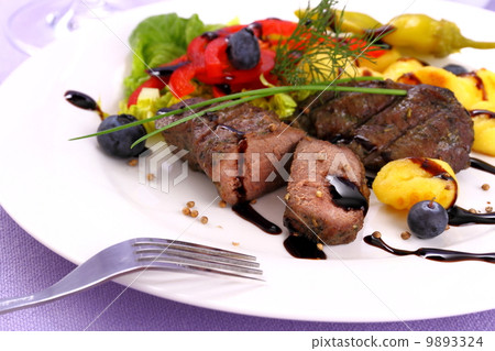 Lamb steak with potato, vegetable and black sauce 9893324