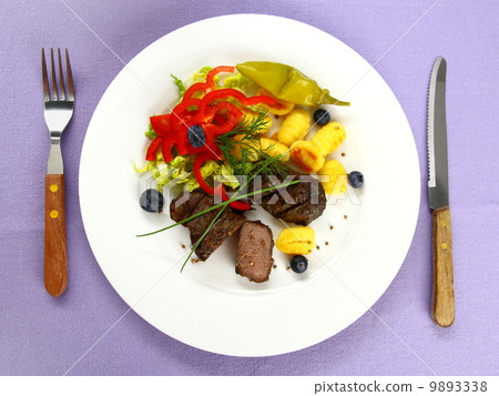 Lamb steak with gnocchi, red peppers and spices 9893338