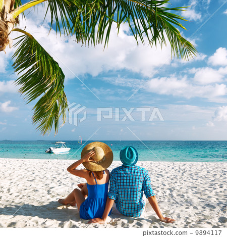 Couple in blue clothes on a beach at Maldives 9894117