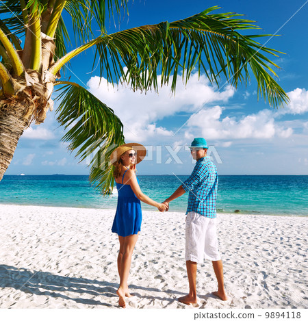 Couple in blue clothes on a beach at Maldives 9894118