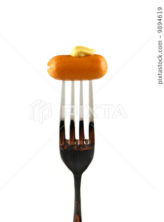 Mini cocktail sausages on fork with mustard 9894619