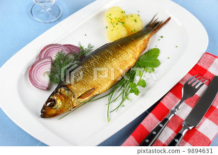Kippers, smoked herring on a white plate with garnish Kippers, smoked herring on a white plate with garnish 9894631