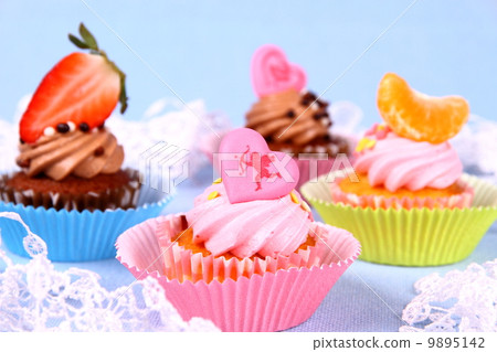 Appetizing cupcakes with angel, heart, tangerine, strawberry Appetizing cupcakes with angel, heart, tangerine, strawberry 9895142